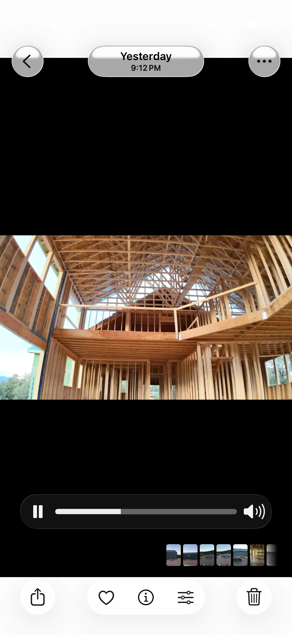 Two-story home framing with wood studs, floor joists, and roof trusses during construction